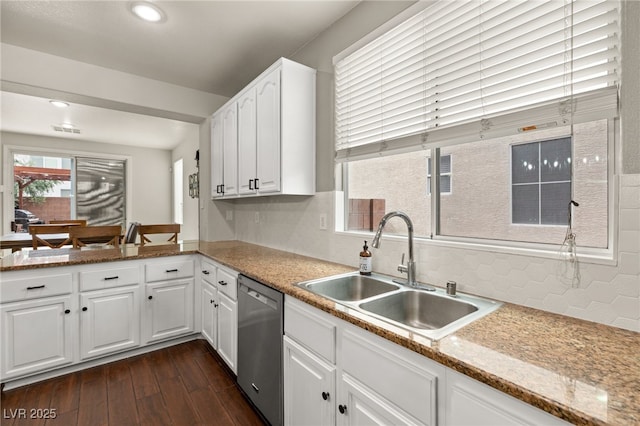 kitchen with dark wood-style floors, a sink, decorative backsplash, white cabinets, and dishwasher