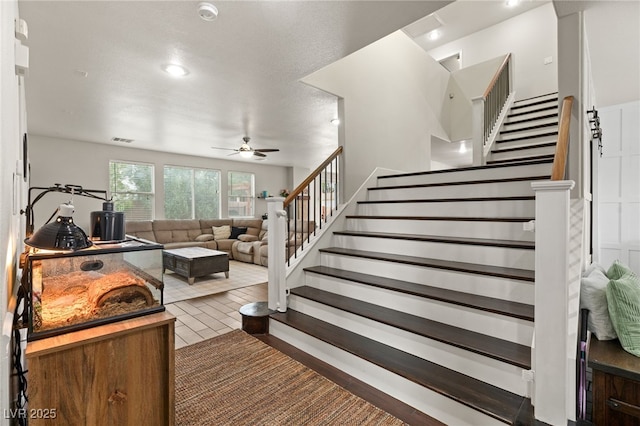 staircase featuring a ceiling fan and visible vents