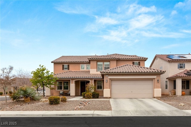 mediterranean / spanish home with concrete driveway, a tiled roof, a garage, and stucco siding