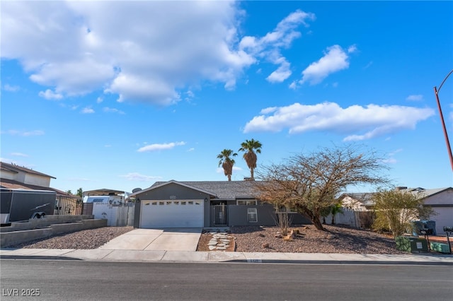 ranch-style home featuring stucco siding, concrete driveway, a garage, and fence