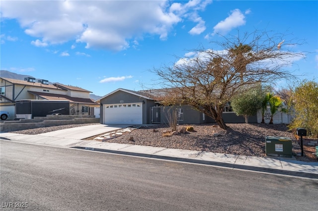 view of front of home featuring concrete driveway, an attached garage, and stucco siding