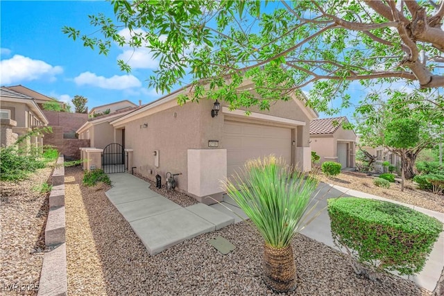 view of home's exterior with a gate, fence, an attached garage, stucco siding, and a tiled roof