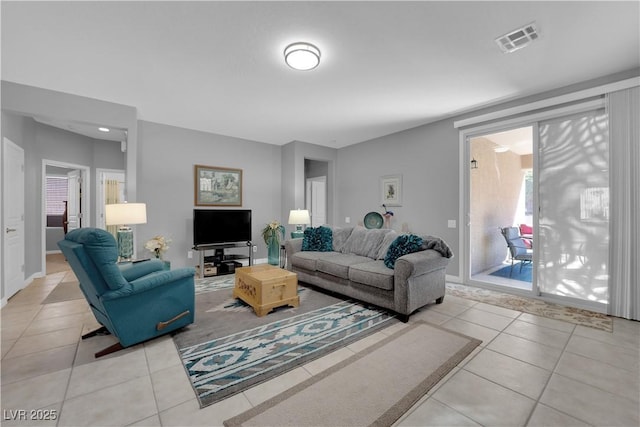 living room with light tile patterned floors and visible vents