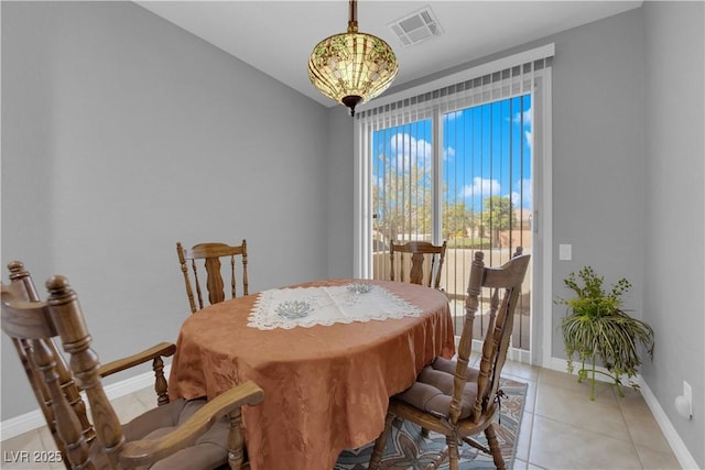 dining space with light tile patterned floors, visible vents, and baseboards