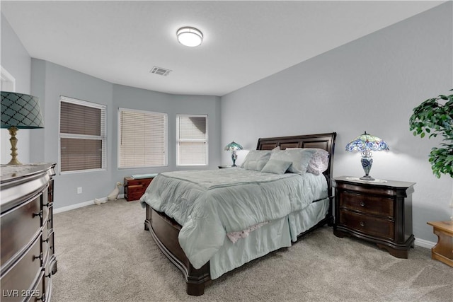 bedroom with visible vents, light carpet, and baseboards