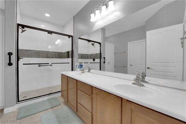 full bath with tile patterned flooring, a sink, a shower stall, and double vanity