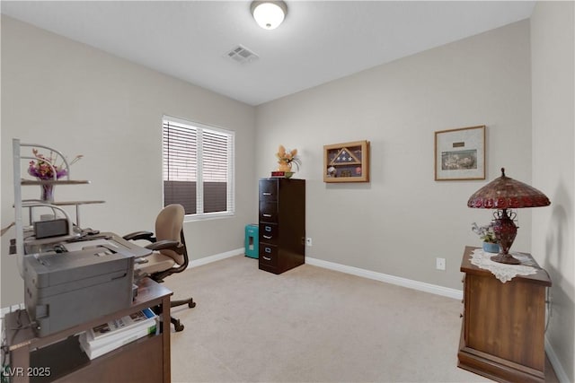 home office featuring visible vents, light carpet, and baseboards