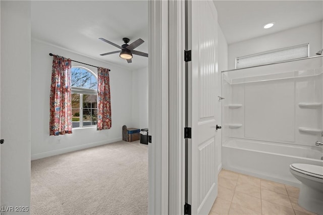 full bath featuring toilet, a ceiling fan, shower / tub combination, tile patterned flooring, and baseboards