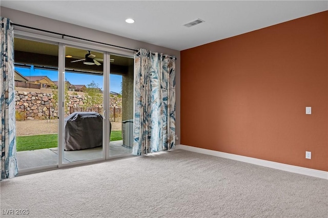 spare room with visible vents, recessed lighting, carpet floors, baseboards, and ceiling fan