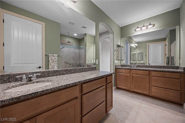 full bath featuring vanity, visible vents, a stall shower, and tile patterned flooring