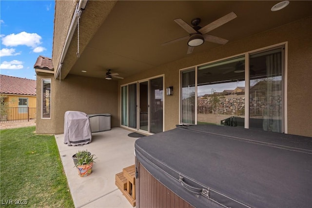 view of patio with fence and ceiling fan