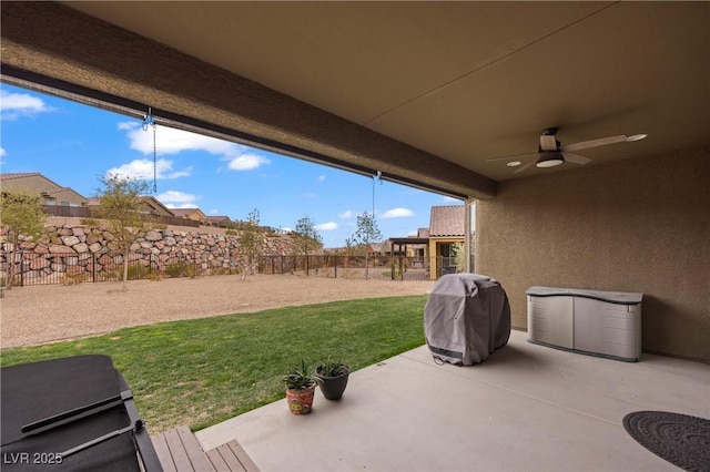 view of patio with a ceiling fan, a fenced backyard, and grilling area