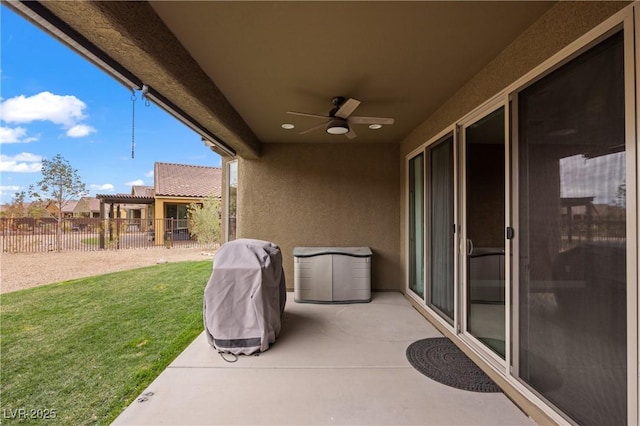 view of patio / terrace featuring a grill, fence, and ceiling fan