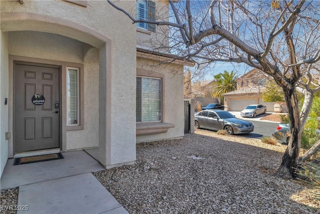 entrance to property featuring stucco siding