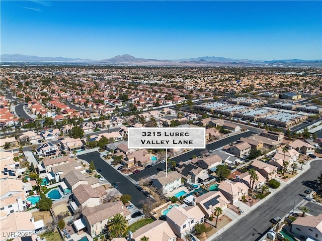 birds eye view of property with a mountain view and a residential view