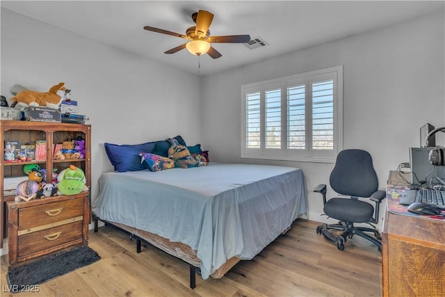 bedroom with visible vents, ceiling fan, and wood finished floors