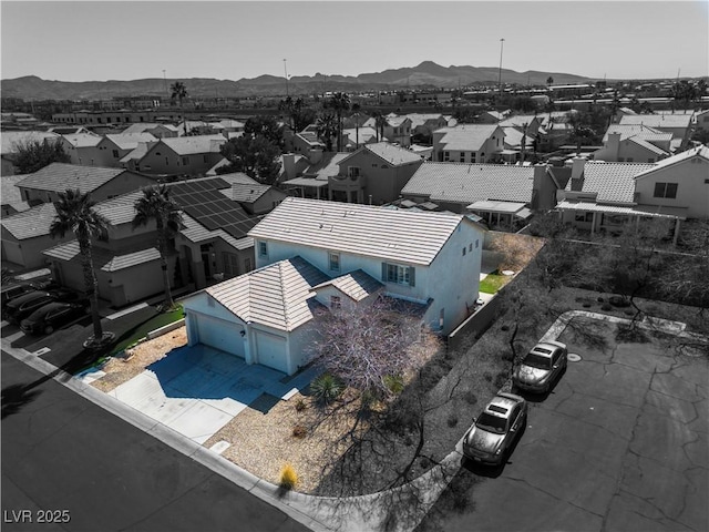 birds eye view of property with a mountain view and a residential view