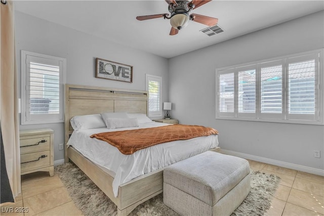 tiled bedroom with a ceiling fan, baseboards, and visible vents