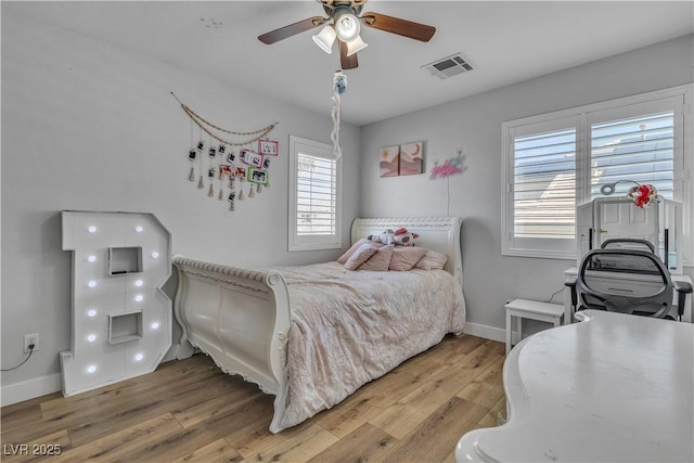 bedroom featuring visible vents, baseboards, a ceiling fan, and light wood finished floors