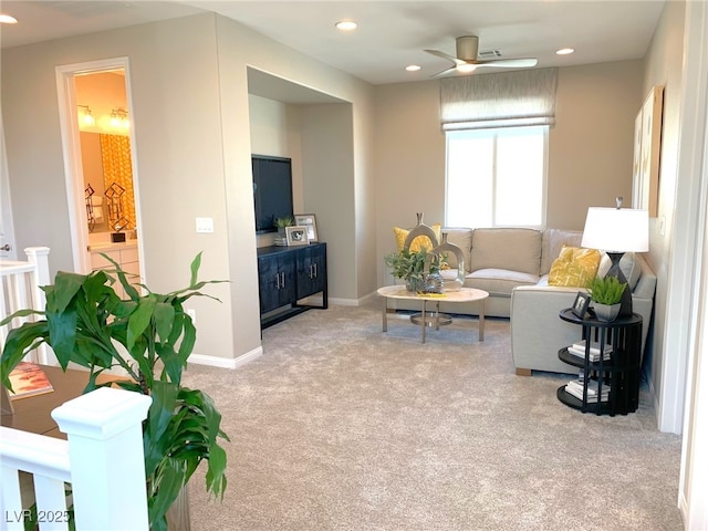 carpeted living area featuring recessed lighting, a ceiling fan, and baseboards