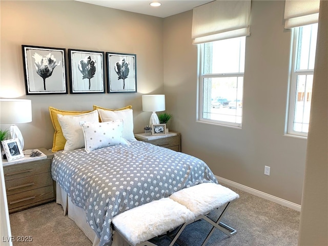 bedroom with baseboards and carpet