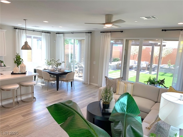 living room featuring visible vents, recessed lighting, light wood finished floors, baseboards, and ceiling fan