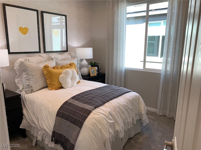 carpeted bedroom featuring wallpapered walls and baseboards