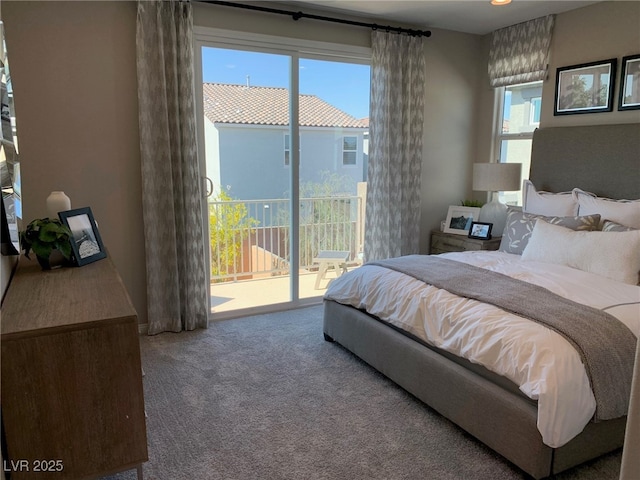 carpeted bedroom featuring multiple windows and access to exterior