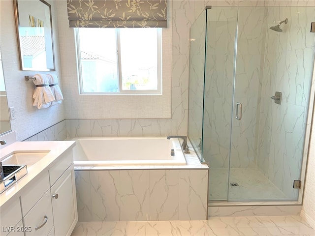 full bathroom with a marble finish shower, marble finish floor, vanity, and a garden tub