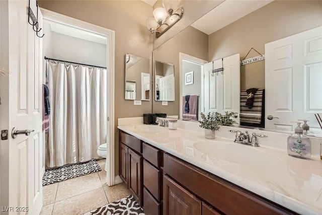 full bathroom with tile patterned flooring, a sink, toilet, and double vanity