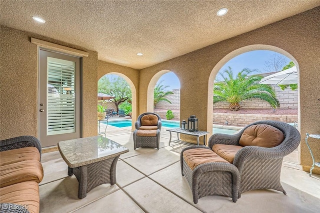 view of patio featuring an outdoor pool and a fenced backyard