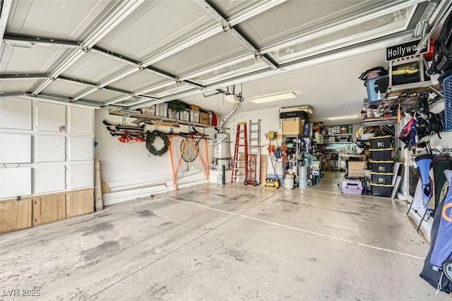 garage with secured water heater and a garage door opener