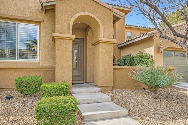 property entrance featuring stucco siding and a tiled roof