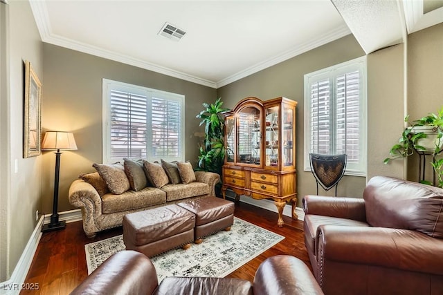 living area featuring dark wood finished floors, crown molding, baseboards, and visible vents