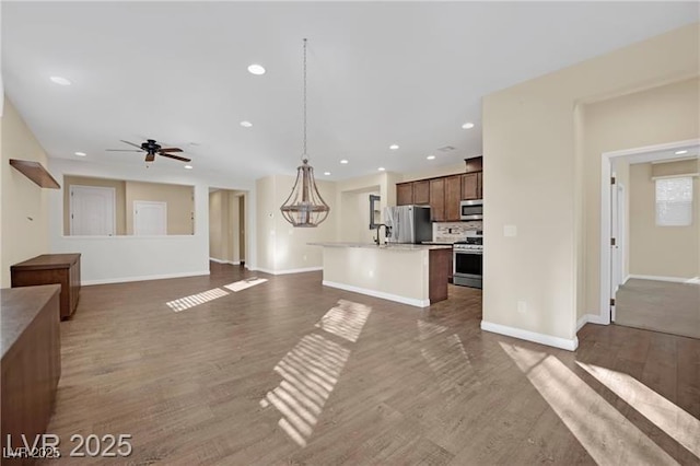 unfurnished living room featuring recessed lighting, dark wood-type flooring, baseboards, and ceiling fan