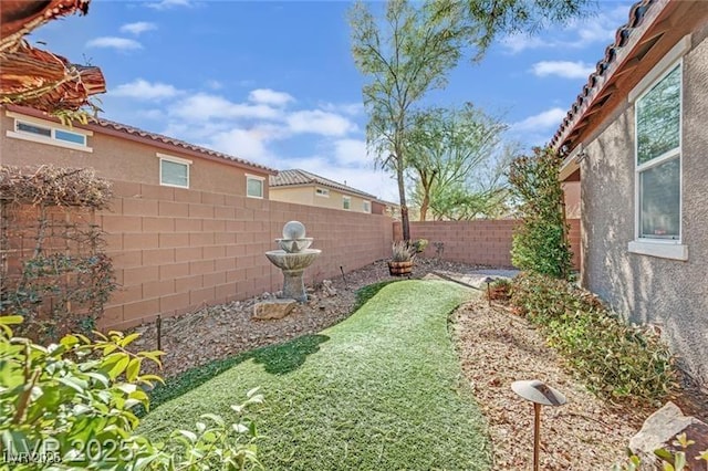 view of yard with a fenced backyard