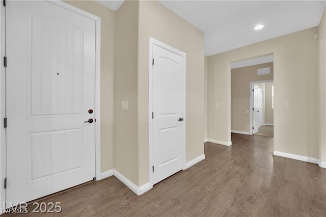 entrance foyer with recessed lighting, wood finished floors, and baseboards