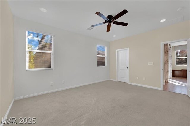 unfurnished bedroom featuring multiple windows, baseboards, and carpet floors