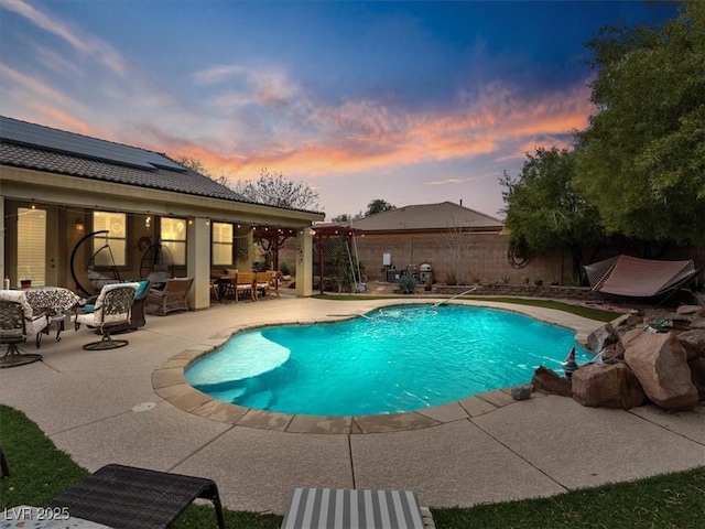 view of pool featuring a patio area, outdoor dining space, a fenced in pool, and fence