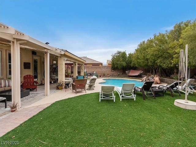 view of swimming pool with a patio area, a yard, a fenced backyard, and a fenced in pool