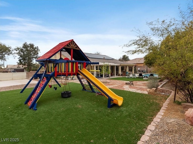 view of play area featuring a patio area, a yard, and fence