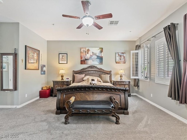 carpeted bedroom with visible vents, baseboards, and ceiling fan