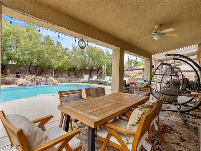 view of swimming pool with outdoor dining space, a fenced backyard, a fenced in pool, ceiling fan, and a patio area