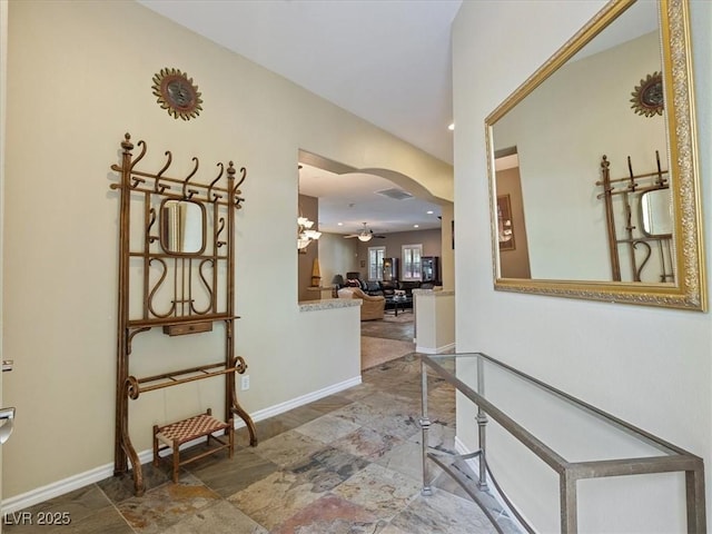 hall featuring recessed lighting, baseboards, and arched walkways