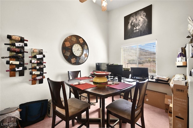 dining space featuring carpet and ceiling fan