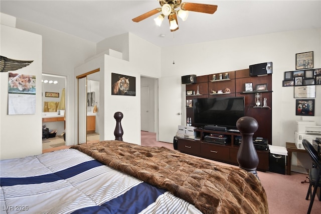 bedroom with a ceiling fan, lofted ceiling, light colored carpet, and ensuite bathroom