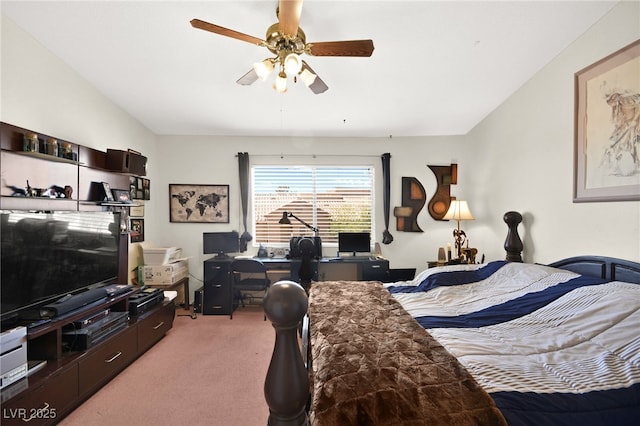 carpeted bedroom with vaulted ceiling and a ceiling fan