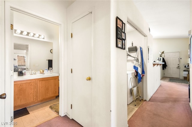 hallway with light tile patterned flooring and light colored carpet