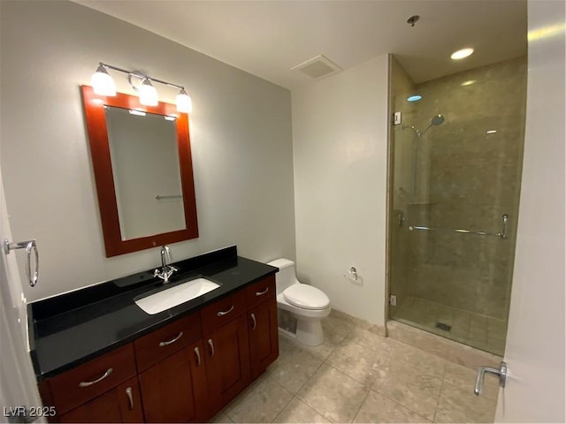 bathroom with tile patterned flooring, a stall shower, toilet, and vanity