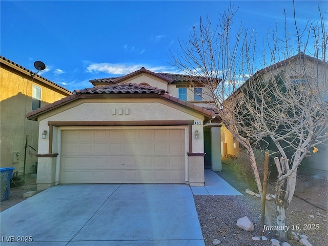 mediterranean / spanish home featuring stucco siding, concrete driveway, an attached garage, and a tiled roof